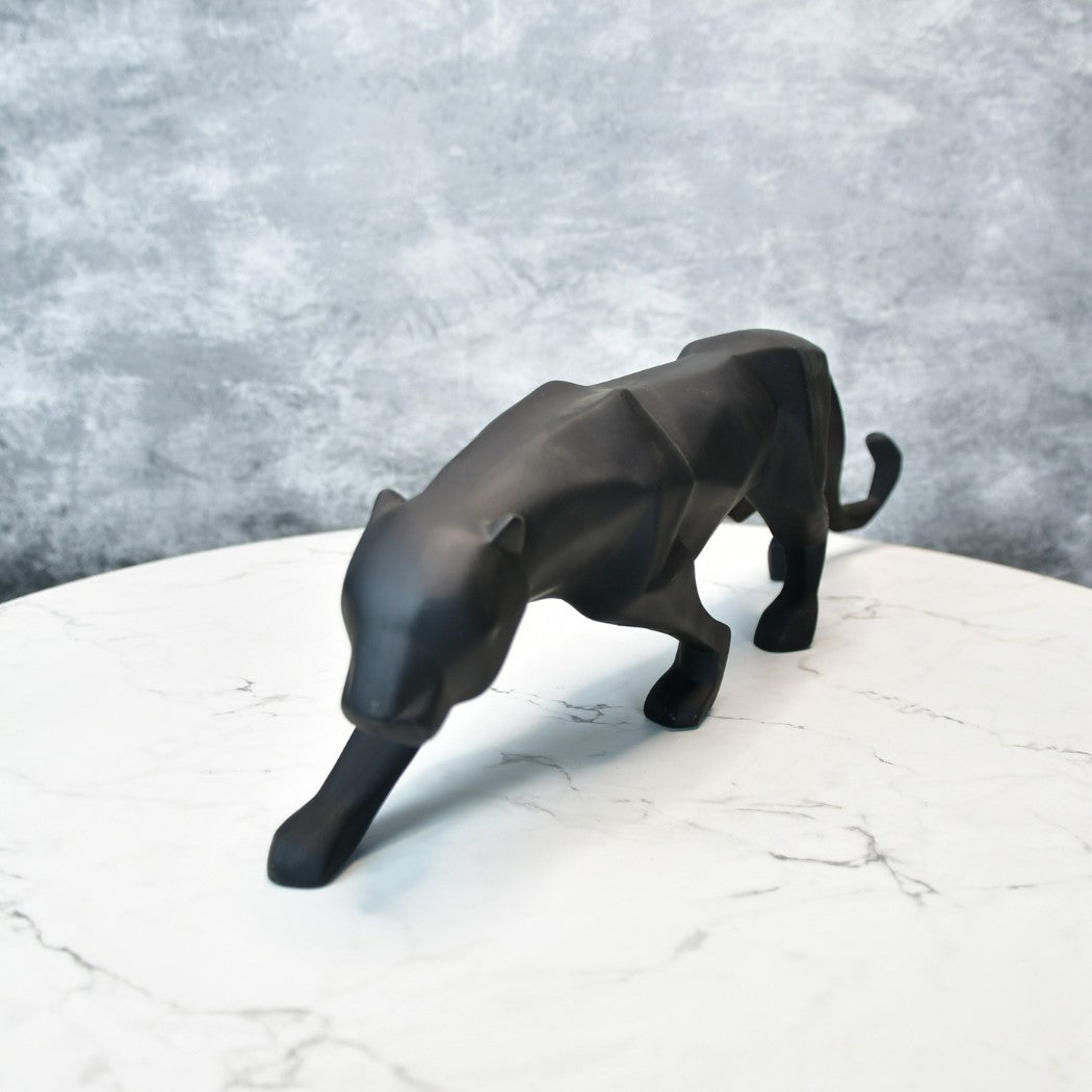 Black resin panther animal figurines for home decor displayed on a marble surface
