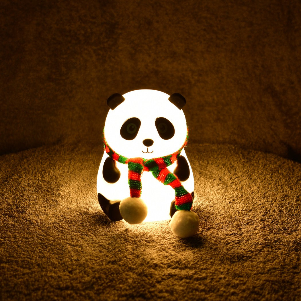 Unique decorative gadgets panda night light with a colorful scarf glowing warmly on a soft surface