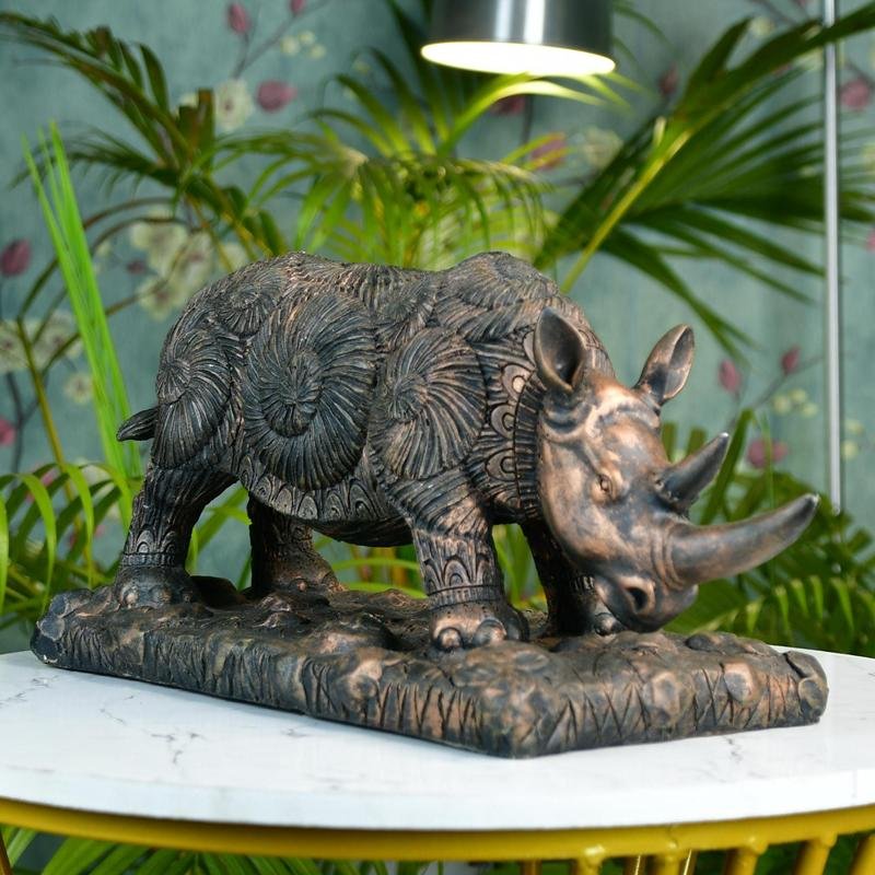 MAYII tabletop rhino home decor statue with intricate carved patterns on a decorative base